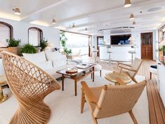 a living room filled with furniture and lots of windows