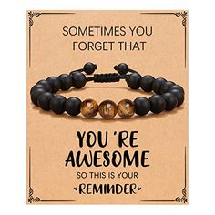 two bracelets with the words you're awesome and reminder written on each one