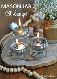 mason jar oil lamps on a wooden tray