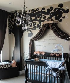 a baby's room decorated in black, white and grey with a tree mural