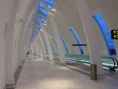 an empty subway station with the lights on