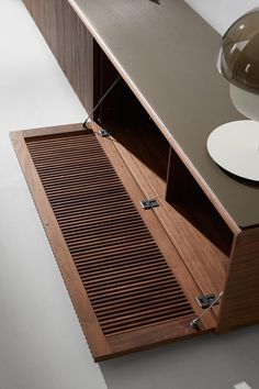 an open cabinet with drawers on the side