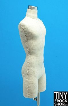 a white mannequin is on display against a blue background