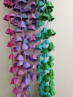 there are many origami umbrellas hanging on the wall