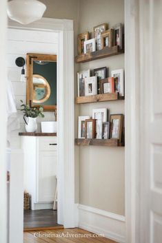 an open door leading into a room with shelves on the wall and pictures on the floor