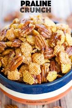 a blue bowl filled with pecans on top of a wooden table