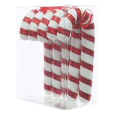 red and white striped candy canes in a clear box on a white background,