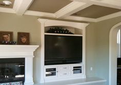 a living room with a fireplace and entertainment center