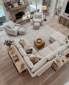 an aerial view of a living room with couches, coffee table and fireplace in the center