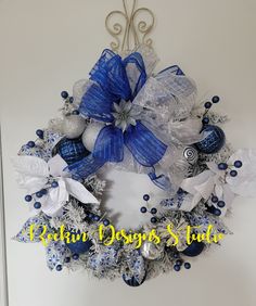 a blue and white christmas wreath hanging on the wall