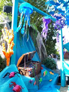 an outdoor area with blue and purple decorations, including jellyfishes and other sea creatures