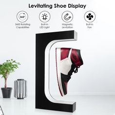 a pair of sneakers are displayed in front of a display letter that reads levitating shoe display