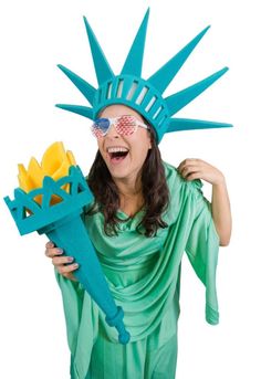 a woman dressed as the statue of liberty holding a fake flower