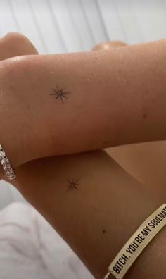 a woman's arm with two small stars on it