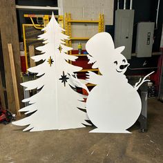 two cut out christmas trees in the shape of bears