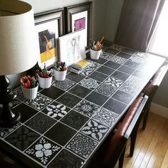 a black and white checkered table cloth with paw prints on it in front of a lamp