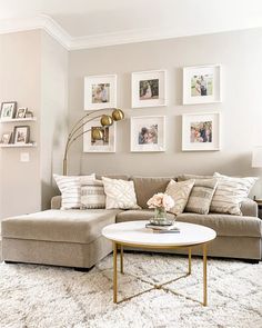 a living room filled with lots of furniture and pictures on the wall above it's coffee table