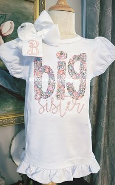 This is the perfect personalized shirt for your newly Big Sister! It comes on a high quality, white, cotton ruffle short or long sleeve shirt. Bow is sold separately. Please choose your fabric and thread color. It can be entered in the personalization box.  When you are selecting the size of the shirt for your child, please keep in mind that it is 100% cotton, and it will shrink a little. The applique is backed with a soft backing to provide protection for sensitive skin from the stitches. Care Bates Sisters Boutique Shirts, Customizable Pink Cotton Shirt, Personalized Short Sleeve T-shirt For Spring, Personalized White Long Sleeve Tops, Personalized Long Sleeve White Tops, Cute Personalized White Tops, Customizable Cute White T-shirt, White Fitted T-shirt For Birthday, White Long Sleeve Shirt For Family Matching