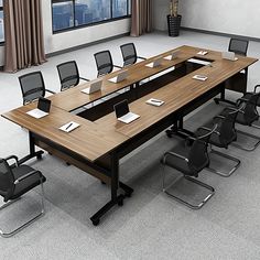 an empty conference table with chairs around it