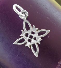 This tiny witch's knot charm features four little crescent moons and the center circle, symbol of protection, eternity and female. It is perfect to wear as a tiny pendant or to add to your charm bracelet. 100% Handmade - I work with pencil, paper, and carving tools. No software, AI or 3D printers are ever used in my handmade pendants. Material: 100% sterling silver, weight: 1.0 grams Dimensions: knot is over 1/2 inch tall x 1/2 inch wide (15 x 15 mm), excluding jump ring Item number: wh265 Witch Handmade Sterling Silver Symbolic Charms, Handmade Symbolic Sterling Silver Charms, Spiritual Sterling Silver Charms, Witch's Knot, Moon Pentacle, Circle Symbol, Necklace Length Guide, Tiny Pendant, Metal Clay Jewelry