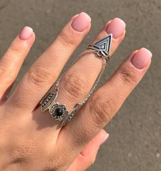 This unusual double ring is made of 925 sterling silver. Two rings are linked with chains, the bottom decorates small beautiful ornaments with a black stone in the middle while the top shows triangle. The work is adjustable, it can fit which finger you prefer. This delicate work will make your look even better. The ring is handmade as all the other goods from our shop. It is a perfect gift both for girls and women. We promise you 100% quality. In case of large orders please send us a private mes Unique Triangle Sterling Silver Jewelry, Silver Triangle Rings For Gifts, Silver Triangle Rings For Gift, Adjustable Silver Ring With Chain, Oxidized Metal Open Ring Jewelry, Adjustable Black Jewelry With Unique Design, Black Adjustable Jewelry With Unique Design, Silver Triangle Metal Jewelry, Nickel-free Silver Triangle Jewelry