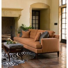 a living room with a couch, coffee table and zebra print rug on the floor