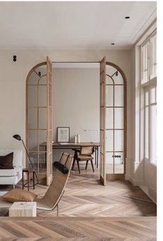 a living room filled with furniture and windows