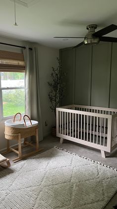 a baby's room with a crib, rocking chair and table in it