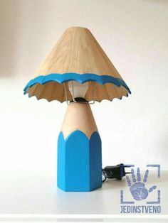 a wooden table lamp with a blue base and a light shade on the top that is shaped like a pencil