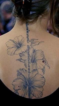 a woman with a flower tattoo on her back