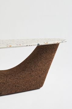 a close up of a table with a white top and brown base on a white background