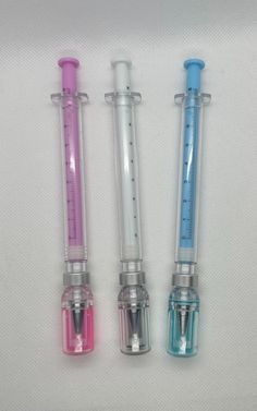 three different types of medical instruments on a white surface with blue and pink trimmings