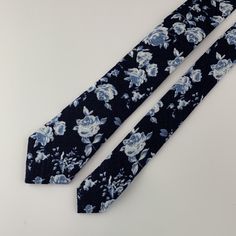 This handmade floral tie is an excellent accessory for weddings, parties, proms - an excellent gift for anyone who enjoys dressing-up dapper! Style: slim/narrow Fabric: 50% cotton / 50% linen Approx. Measurements: (W) 2.4 in. x (L) 58 in. Care: Dry clean only Classic Floral Print Wedding Tie, Blue Ties For Wedding Neckwear, Blue Wedding Neckwear With Ties, Elegant Floral Print Suit And Tie Accessories For Wedding, Blue Standard Tie For Wedding, Elegant Adjustable Suit And Tie Accessories With Floral Print, Wedding Suit Accessories With Floral Print Standard Tie, Elegant Adjustable Floral Print Suit And Tie Accessories, Floral Print Standard Tie For Wedding