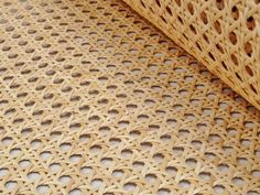 a close up view of a woven material with holes in the center and on the outside