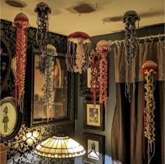 a room filled with lamps and pictures on the wall next to a lamp shade in front of a mirror