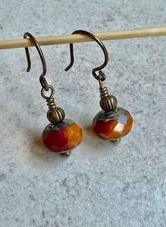 "tiny red orange earrings   small boho dangle earrings   1\" czech glass earrings These faceted Czech glass beads are both deep red and mango orange with a Picasso coating at their tops and bottoms. I positioned the beads so both colors are visible from the front. Each bead is topped with a tiny antiqued brass bead. Small hook ear wires are antiqued brass. Length of earrings from top of ear wires is 1\". Glass bead measures 6x8mm. You can enter my shop here: gypsydangles.etsy.com" Cheap Artisan Earrings With Tiny Beads, Cheap Czech Glass Beaded Earrings With Round Beads, Unique Cheap Czech Glass Earrings, Cheap Hypoallergenic Czech Glass Earrings, Cheap Czech Glass Beaded Earrings For Party, Cheap Czech Glass Dangle Earrings, Cheap Gold Beaded Earrings With Czech Glass, Cheap Red Czech Glass Earrings, Earring Shapes