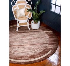 a chair sitting on top of a wooden floor next to a potted plant