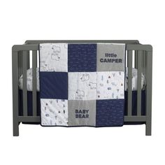 a baby crib with a blue and gray blanket