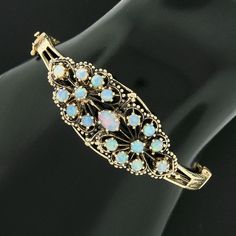 Victorian Revival 14k Gold Cabochon Opal Engraved Sides Hinged Bangle Bracelet Antique Multi-stone Bracelet For Formal Occasions, Antique Multi-stone Bracelets For Formal Occasions, Ornate Multi-stone Collectible Jewelry, Bracelet Displays, Open Bangle Bracelet, Victorian Revival, Precious Opal, Bracelet Display, Open Bangle