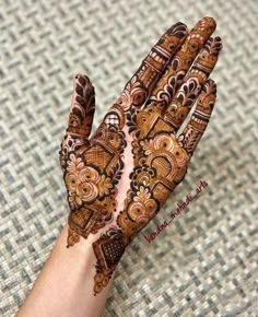 a person's hand is decorated with hennap and intricate designs on it