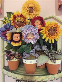 there are many sunflowers in the potted planter with faces on them