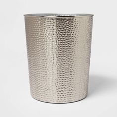 a silver metal cup on a white background, with the lid slightly open to reveal an interesting texture