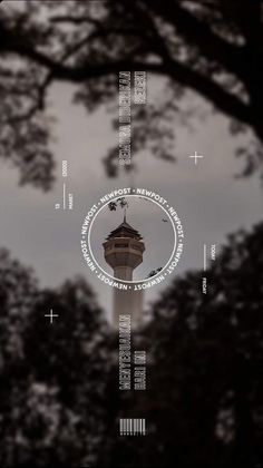 the tower is surrounded by trees and has a circular design on it's side