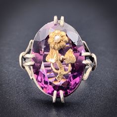 Victorians loved to use flowers as symbolism of certain attributes, as well as a means for secret communication between friends and lovers. This large amethyst ring is set in silver, with a golden daisy motif riveted into the sparkling purple gem. In the Victorian Language of Flowers, the daisy represents youth, purity and innocence. With a tiny natural seed pearl at its center, it is a beautiful little artwork of yesteryear, in fabulous shape to wear today! Details (approximate) Size: 7 Weight: 5.4 grams Materials: Gold, Silver, Amethyst, Seed Pearl Marks: None Condition: Excellent Antique condition commensurate with age and wear. Circa 1880 This piece can be resized, resize options are $25 more than the base size. Victorian Style Purple Amethyst Ring For Anniversary, Heirloom Style Purple Amethyst Sterling Silver Ring, Heirloom Purple Amethyst Ring In Sterling Silver, Heirloom Style Purple Amethyst Collectible Ring, Collectible Purple Amethyst Ring With Center Stone, Fine Amethyst Ring For Collectors, Unique Purple Amethyst Ring For Wedding, Antique Purple Amethyst Ring With Accent Stones, Unique Purple Amethyst Wedding Ring