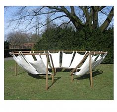 an outdoor hammock set up in the grass