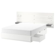 a white bed with two drawers underneath it