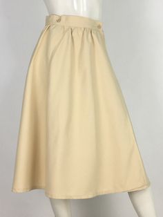 "60s swing skirt, wrap skirt, off white wrap midi skirt  mannequin measures 5ft 8\", bust 34\", waist 25\", hip 33\" Measurements:  waist 13\"/hip 23\"-open/length 28\"/width of bottom 40\" Please note that vintage clothing sizes can vary greatly.  The Measurements provided are taken with garment lying flat.  I suggest taking a similar garment from your wardrobe and measure it while lying flat.  This way you can compare measurements.   Please note buyer is responsible for any duties, taxes or customs clearance fees imposed by their country. Be sure to check in often as new gems are added daily.. **all sales are final." Beige Lined Maxi Skirt For Daywear, Cream Skirt For Daywear, Cream Relaxed Fit Skirt For Daywear, Beige Midi Dress With Lined Skirt, Beige Flowy Lined Wrap Skirt, Cream Fitted Flared Maxi Skirt, Fitted Flared Cream Maxi Skirt, Flowy Beige Lined Wrap Skirt, Fitted Cream Flared Maxi Skirt