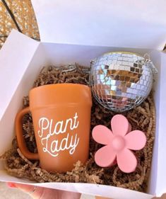 a box with a coffee cup, mirror ball and flower on the lid that says plant lady