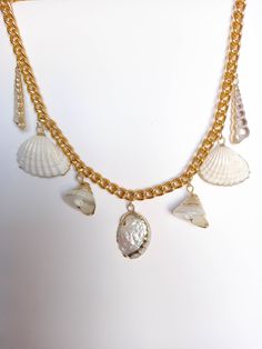 "Unused vintage statement seashell chain necklace with 24K edged seashell charms. The chain is made of aluminum with a gold tone plate of excellent quality and lightweight. This bold necklace is a great an original and daring piece, which will look great as part of a dress up occasion any time of the year, and also a lovely complement for a beach wedding. Please note that the shells may show small irregularities, as occurs in nature. MEASUREMENTS: Length not including clasp: 17.6\" = 44.5 cm. Ch Handmade Vintage Gold Shell Necklace, White Chain Necklace For Beach, White Chain Necklace For The Beach, Gold Chain Jewelry For Vacation, Vintage Shell Gold Jewelry, Vintage Gold Beach Jewelry, Vintage Gold Jewelry For Beach, Vintage Gold Jewelry For The Beach, Gold Shell Necklace With Pearl Chain For Beach