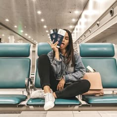 a woman sitting on a bench with her head in her hands while reading a book